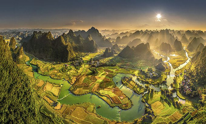 Quay Son River is surrounded by golden rice fields and karst limestone mountains in Cao Bang Province. Photo by Tran Bao Hoa